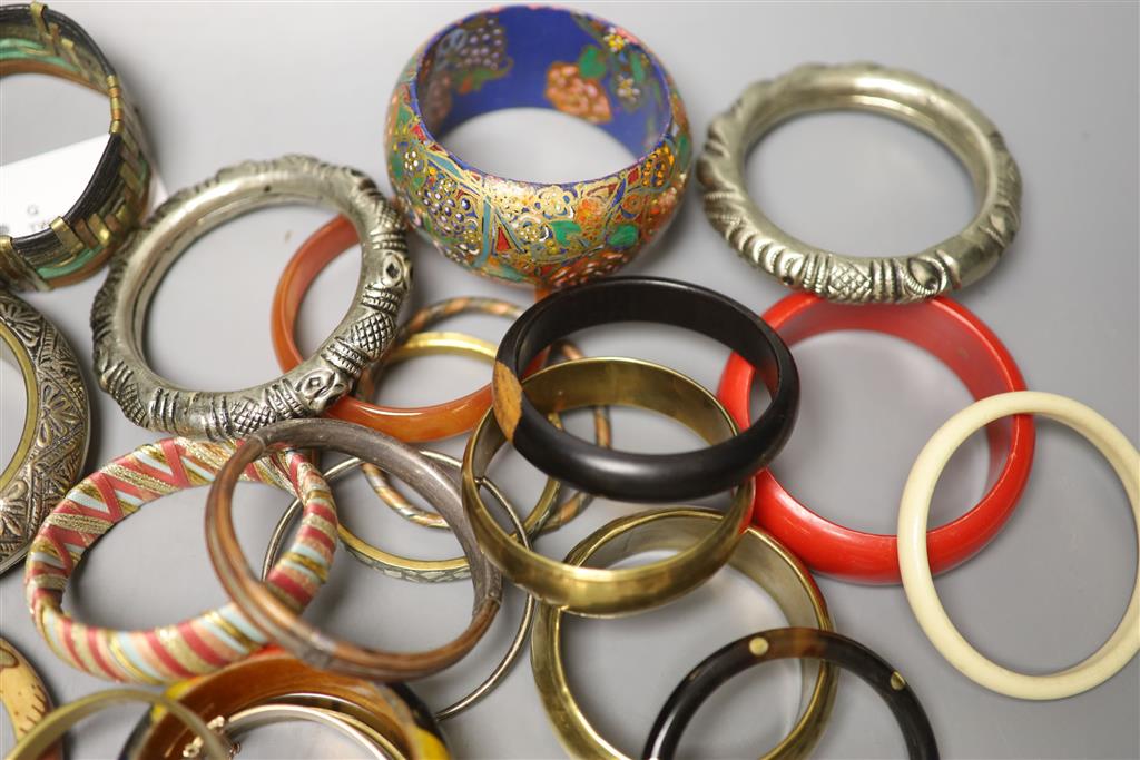 A collection of bangles, including five ethnic white metal examples,